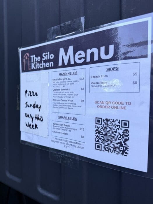 Menu Sign on Dark Wall Reading the Silo Kitchen with Large menu Title and a Qr Code on the Right Side
