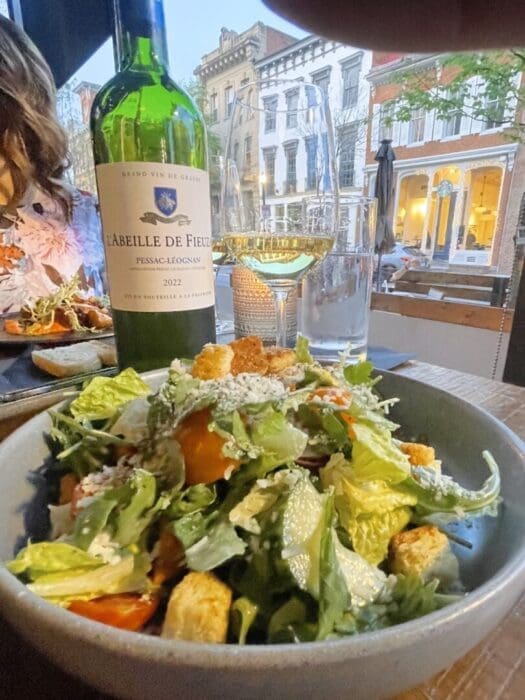 A salad appetizer paired with Bordeaux Savignion Blanc wine. At The Tasting Room restaurant in downtown Frederick, MD.