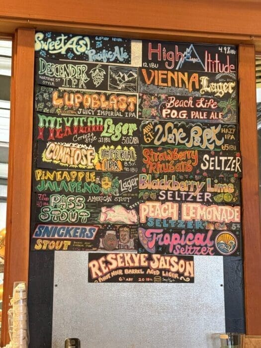 Colorful Chalkboard Beer and Seltzer Menu with Creative Stylized Text and Illustrations Names Like Lupoblast Descender Ipa and Peach Lemonade Seltzer Are Displayed Each with Unique Fonts Colors and Small Decorative Drawings