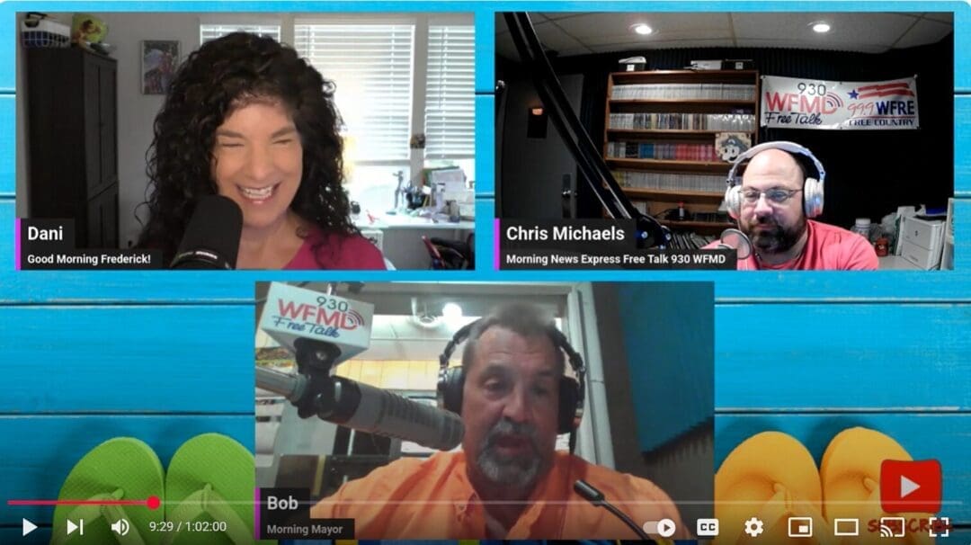 A video call for Everything Frederick LIVE features three radio hosts: Dani (top left, smiling with curly hair), Chris Michaels (top right, bald with glasses in a studio), and Bob (bottom, speaking into a microphone). WFMD logos are visible.