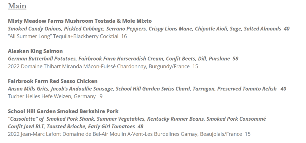 a Restaurant Menu Section Labeled Main at Market Table Bistro Lists Four Entrees Mushroom Tostada Alaskan King Salmon Red Sasso Chicken and Berkshire Pork Each with Detailed Descriptions Prices and Suggested Wine or Beer Pairings Text is Brown on a White Background